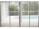 Patio doors giving access to a screened-in lanai area and the lovely pool at 8025 Old Town Dr, Orlando, FL 32819