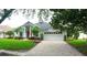 Charming single-story home with a two-car garage, well-manicured lawn, and mature trees at 8025 Old Town Dr, Orlando, FL 32819