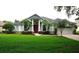 Charming single-Gathering home with a well-manicured lawn, beautiful landscaping, and a striking red front door at 8025 Old Town Dr, Orlando, FL 32819