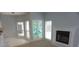 Bright living room with fireplace, neutral carpet and patio doors leading to the pool area at 8025 Old Town Dr, Orlando, FL 32819