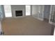 Cozy living room with fireplace and neutral carpet, bathed in natural light from two large windows at 8025 Old Town Dr, Orlando, FL 32819