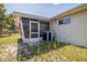 The back exterior has vinyl siding and a well-manicured lawn at 8426 Sw 114Th St, Ocala, FL 34481