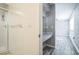 Bathroom featuring a walk-in shower and a stylish vanity area, enhanced by modern wood flooring at 8426 Sw 114Th St, Ocala, FL 34481