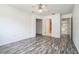 Bedroom boasts modern wood floors, a ceiling fan, and direct access to ensuite bathroom at 8426 Sw 114Th St, Ocala, FL 34481