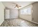 Bedroom featuring stylish wood floors, ceiling fan, neutral walls, and ample natural light at 8426 Sw 114Th St, Ocala, FL 34481