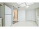 Bright kitchen with white appliances and cabinetry, and a tiled floor with skylight at 8426 Sw 114Th St, Ocala, FL 34481