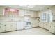 Functional kitchen with white appliances, ample counter space, and white tiled floors provides a clean aesthetic at 8426 Sw 114Th St, Ocala, FL 34481