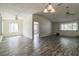 Expansive living area boasts stylish floors, ceiling fans, and ample natural light creating a welcoming ambiance at 8426 Sw 114Th St, Ocala, FL 34481