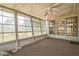 A sunroom with multiple windows offering natural light and views of the outdoors at 8426 Sw 114Th St, Ocala, FL 34481