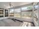 A sunroom with multiple windows and fan provides a relaxing space at 8426 Sw 114Th St, Ocala, FL 34481