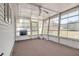 An enclosed sunroom features large windows and a carpeted floor, inviting relaxation at 8426 Sw 114Th St, Ocala, FL 34481