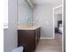Bathroom with sleek vanity, large mirror, and doorway to another room, perfect for convenience at 936 Calabria Ave, Davenport, FL 33897
