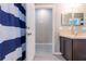 Bathroom featuring a view to another room, shower with blue curtain and nice vanity at 936 Calabria Ave, Davenport, FL 33897