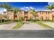 Attractive townhouses boast tropical landscaping, palm trees, brick driveways, and colorful exteriors at 936 Calabria Ave, Davenport, FL 33897