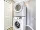 Efficient laundry area features a stacked washer and dryer, maximizing space and convenience at 936 Calabria Ave, Davenport, FL 33897