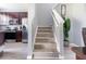 Staircase leads to upper level near kitchen with stainless appliances and wood flooring at 936 Calabria Ave, Davenport, FL 33897