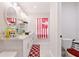 Well-lit bathroom featuring white cabinets, modern fixtures, and a decorative mirror at 999 Trumbull St, Deltona, FL 32725