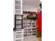 Organized closet with plastic containers, shelves, and hanging clothes at 999 Trumbull St, Deltona, FL 32725