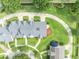 An aerial view of a gray-roofed home with beautiful landscaping and greenery at 104 Nautica Mile Dr, Clermont, FL 34711