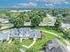 Aerial view showcases the property's well-manicured lawn, mature trees, and convenient street access at 104 Nautica Mile Dr, Clermont, FL 34711