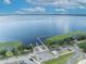 Scenic aerial view of the lake with a boat ramp and a small building surrounded by lush green trees at 104 Nautica Mile Dr, Clermont, FL 34711