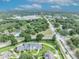 Stunning aerial view of a luxury home surrounded by lush greenery and manicured lawns in a quiet neighborhood at 104 Nautica Mile Dr, Clermont, FL 34711
