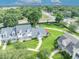 An aerial view captures the property with manicured lawns, mature trees, and proximity to local streets at 104 Nautica Mile Dr, Clermont, FL 34711