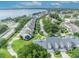 Scenic aerial view of a neighborhood near a lake, featuring charming homes with colorful sunrooms at 104 Nautica Mile Dr, Clermont, FL 34711
