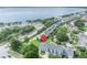 Overhead view pinpoints a property near a lake, surrounded by well-kept lawns and colorful sunrooms at 104 Nautica Mile Dr, Clermont, FL 34711
