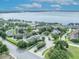 Panoramic aerial view of a lakeside community featuring homes, lush greenery, and waterfront access at 104 Nautica Mile Dr, Clermont, FL 34711