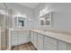Bright bathroom featuring a glass shower, double sinks, and wood-look flooring at 104 Nautica Mile Dr, Clermont, FL 34711