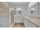Bright bathroom featuring a glass shower, double sinks, and wood-look flooring at 104 Nautica Mile Dr, Clermont, FL 34711