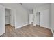 Neutral bedroom features wood-look flooring and multiple doors leading to other rooms at 104 Nautica Mile Dr, Clermont, FL 34711
