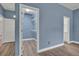 Spacious walk-in closet with white shelving and blue walls and wood-look flooring at 104 Nautica Mile Dr, Clermont, FL 34711