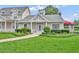 Inviting single-story home showcases lush landscaping and a welcoming front porch at 104 Nautica Mile Dr, Clermont, FL 34711