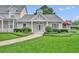 Charming single-story home featuring a well-manicured lawn and inviting front entrance at 104 Nautica Mile Dr, Clermont, FL 34711