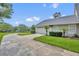 Attractive home featuring a circular driveway, lush green lawn, and a two car garage at 104 Nautica Mile Dr, Clermont, FL 34711
