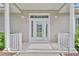 Inviting front door with sidelights, columns, and transom window, creating an elegant entrance at 104 Nautica Mile Dr, Clermont, FL 34711