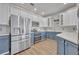 Modern kitchen featuring stainless steel appliances and stylish two-tone cabinets at 104 Nautica Mile Dr, Clermont, FL 34711