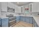 Bright kitchen with stainless steel oven, blue cabinets, and white countertops at 104 Nautica Mile Dr, Clermont, FL 34711