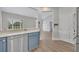 Open kitchen with stainless steel dishwasher and blue cabinets, connected to other rooms at 104 Nautica Mile Dr, Clermont, FL 34711