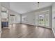 Spacious living room with light wood-look floors, tall ceilings, and ample natural light at 104 Nautica Mile Dr, Clermont, FL 34711