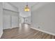 Bright living room with hardwood floors, neutral walls, and an ornate light fixture overhead at 104 Nautica Mile Dr, Clermont, FL 34711