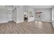 Open-concept living room features light wood-look floors, high ceilings, and access to the kitchen at 104 Nautica Mile Dr, Clermont, FL 34711