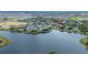 Scenic aerial view of lakefront condos, surrounding neighborhood, and lush greenery at 110 Watling Way # 25204, Davenport, FL 33837