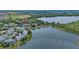 Scenic aerial view of lakefront condos, surrounding neighborhood, and lush greenery at 110 Watling Way # 25204, Davenport, FL 33837