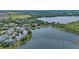 Scenic aerial view of lakefront condos, surrounding neighborhood, and lush greenery at 110 Watling Way # 25204, Davenport, FL 33837