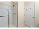 Functional bathroom featuring tiled shower and a door, enhancing convenience at 110 Watling Way # 25204, Davenport, FL 33837