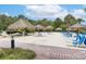 Sandy beach area featuring lounge chairs, umbrellas, and a hammock at 110 Watling Way # 25204, Davenport, FL 33837