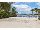A beach volleyball court with beach chairs near the water's edge at 110 Watling Way # 25204, Davenport, FL 33837